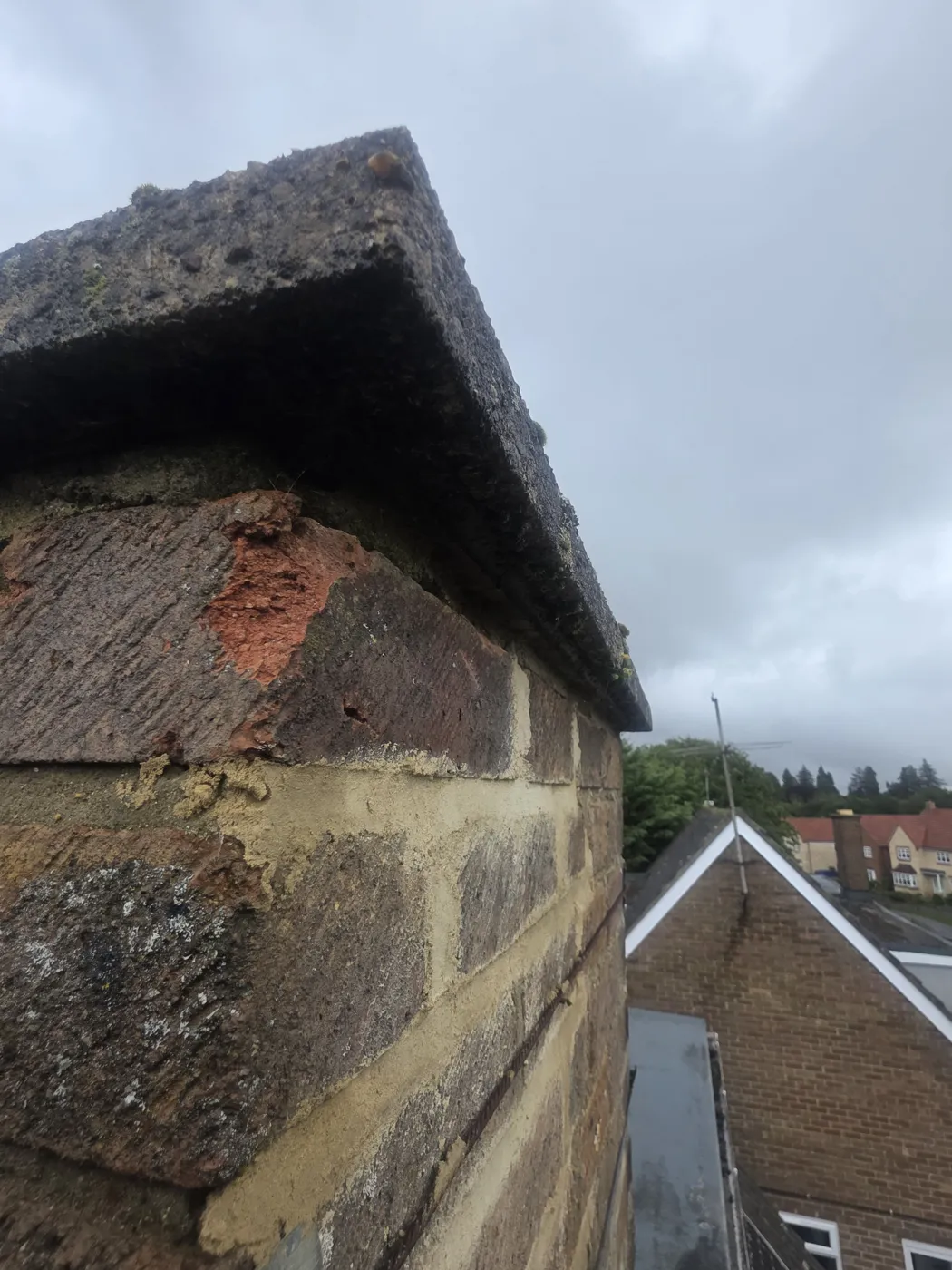 Deteriorated chimney brickwork and mortar identified during inspection before repair.
